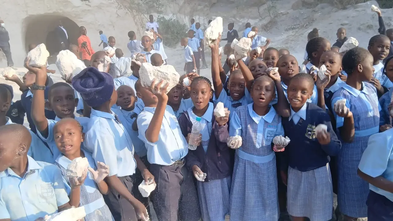 Students examining rock samples on a field trip